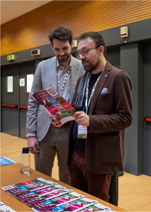 Myself (left) and current MCAA Chair Gian Maria Greco (right), making sure that the print version of the MCAA IRRADIUM magazine that we had worked on was actually the correct one. Photo taken during the Annual Conference in Milan, 2024